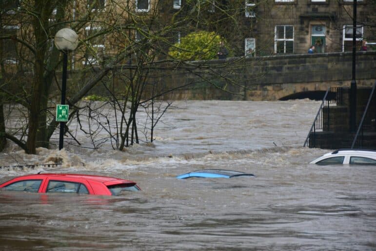 Image of severe flooding with cars under water.